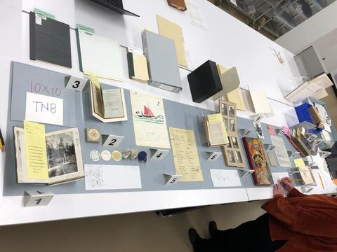 Layout planning photo of all items to be included in the seventh section of the north table case on the ground floor of the Beinecke Library. 