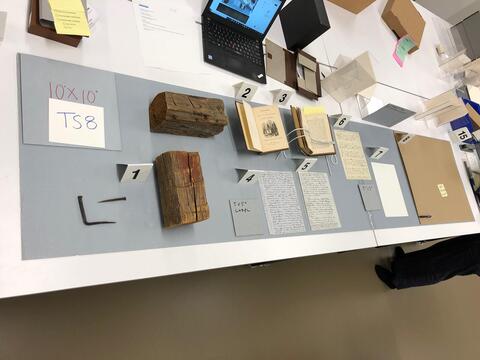 Layout planning photo of all items to be included in the eighth section of the south table case on the ground floor of the Beinecke Library.