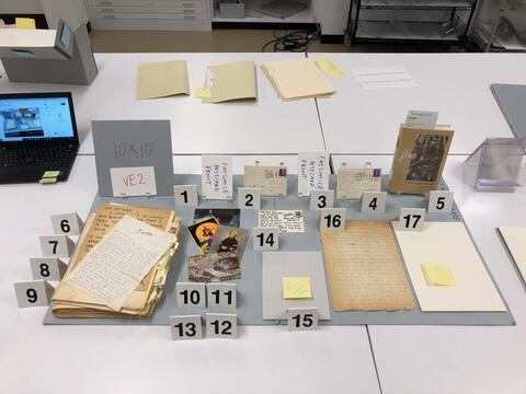 Layout planning photo of all items to be included in the second vintrine case on the east side of the Beinecke Library. 