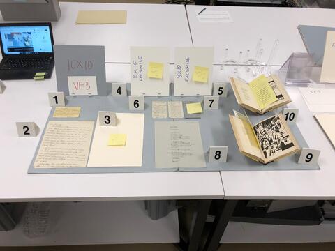 Layout planning photo of all items to be included in the third vintrine case on the east side of the Beinecke Library. 