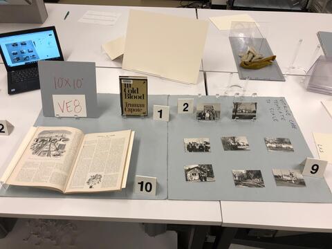 Layout planning photo of all items to be included in the eighth vintrine case on the east side of the Beinecke Library. 