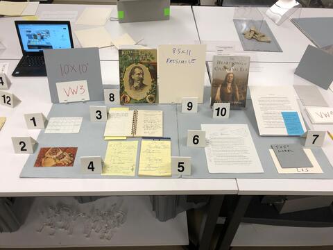 Layout planning photo of all items to be included in the third vintrine case on the west side of the Beinecke Library. 